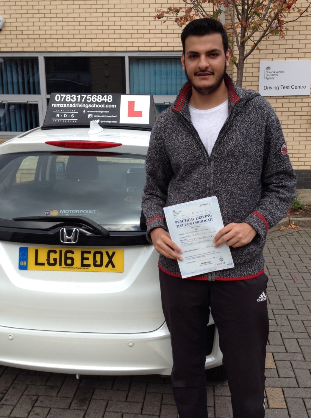 Image of a learner driver showing their test certificate