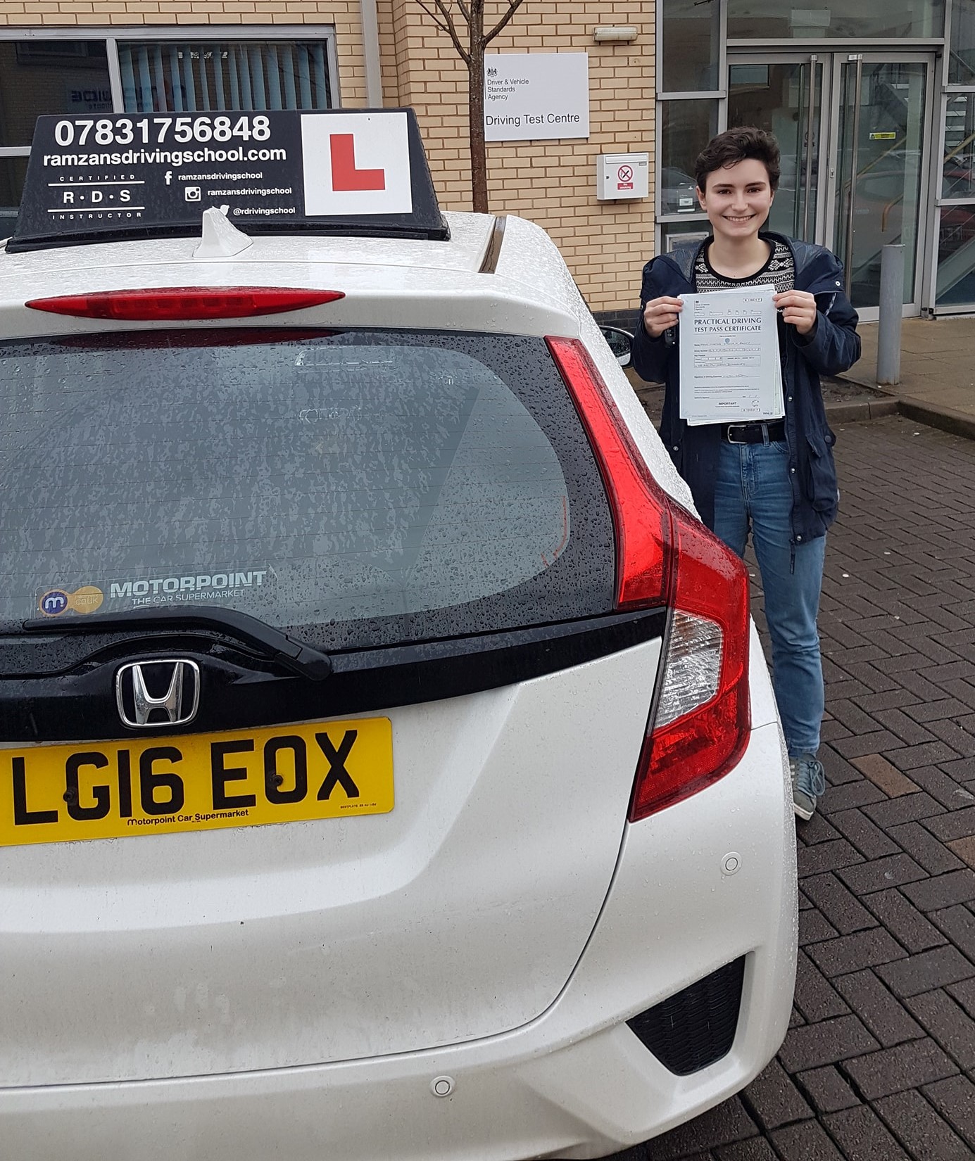 Image of a learner driver showing their test certificate