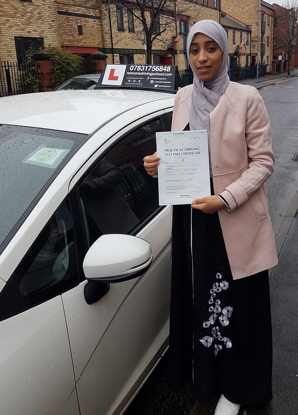 Image of a learner driver showing their test certificate