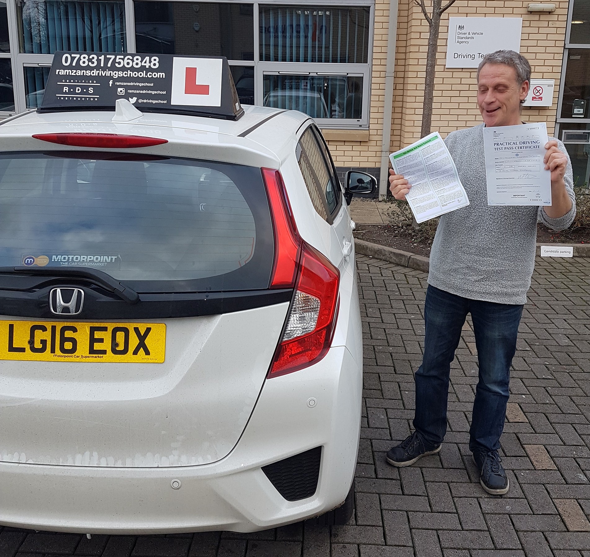 Image of a learner driver showing their test certificate