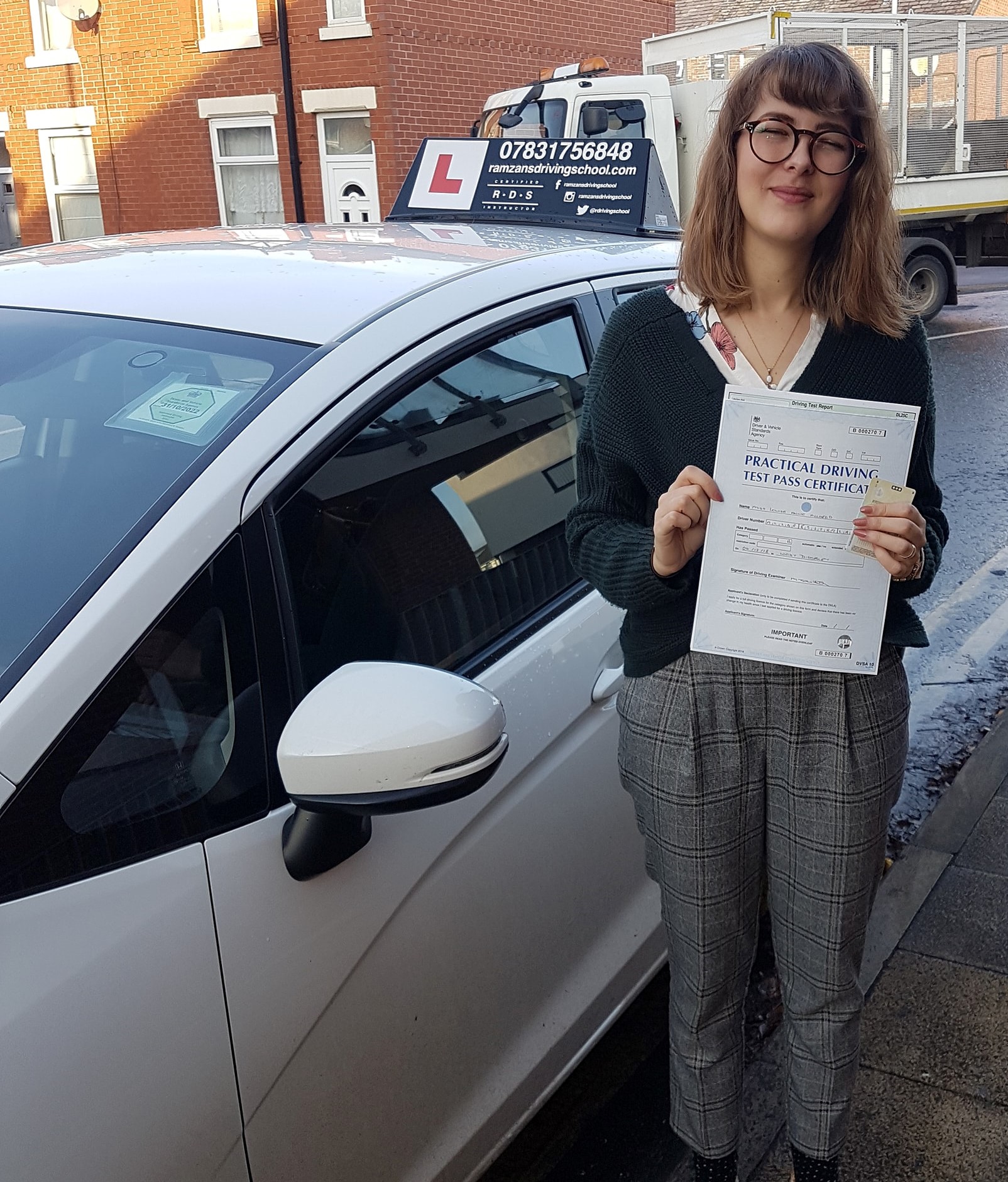 Image of a learner driver showing their test certificate